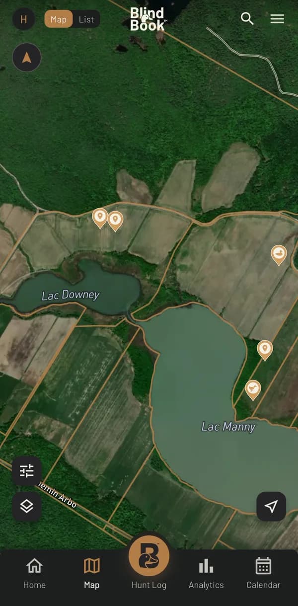 The BlindBook app's Map tab on a real hunt trip: satellite view with parcel lines and waypoint pins around two lakes